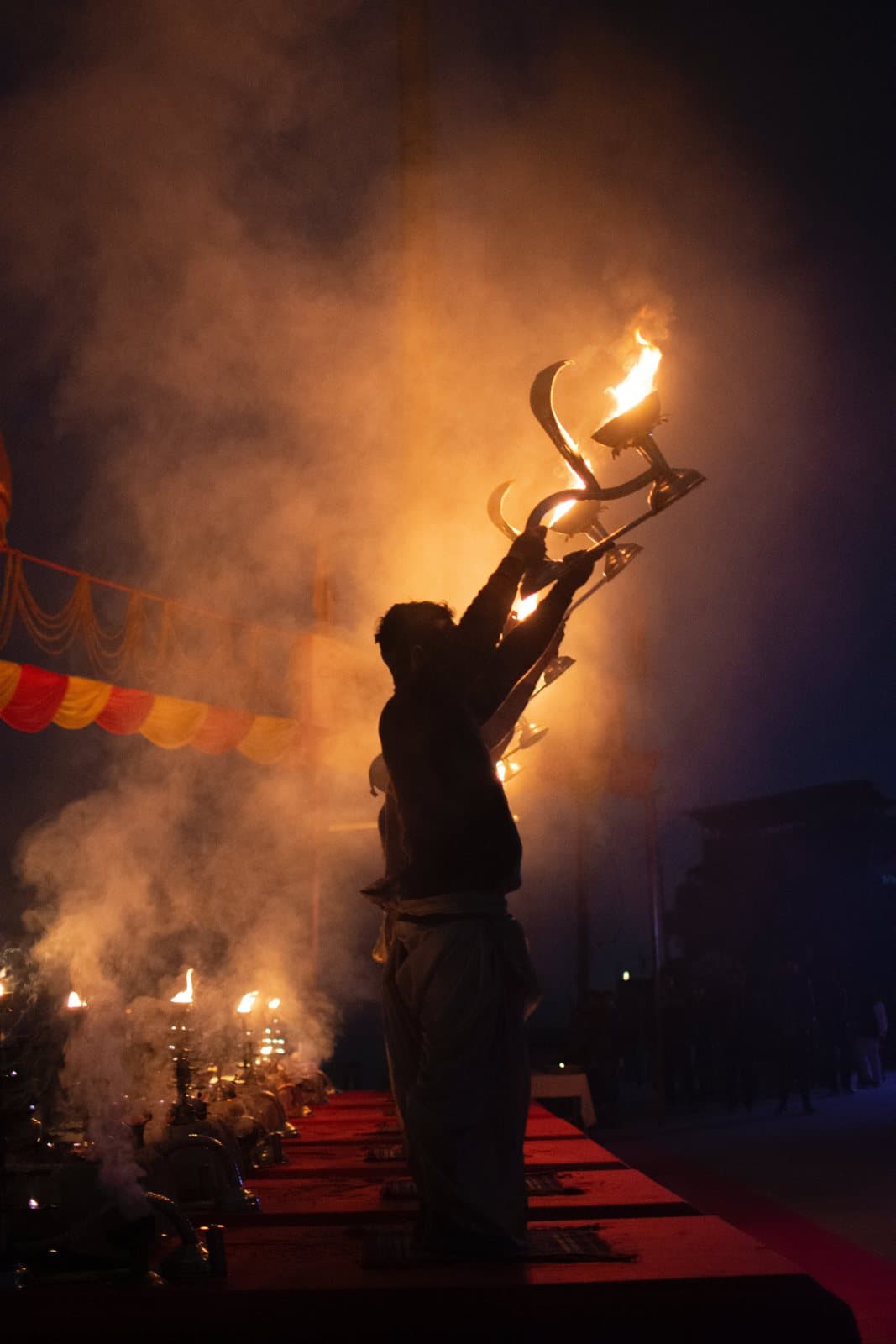 A pandit with the Aarti lamp and incense